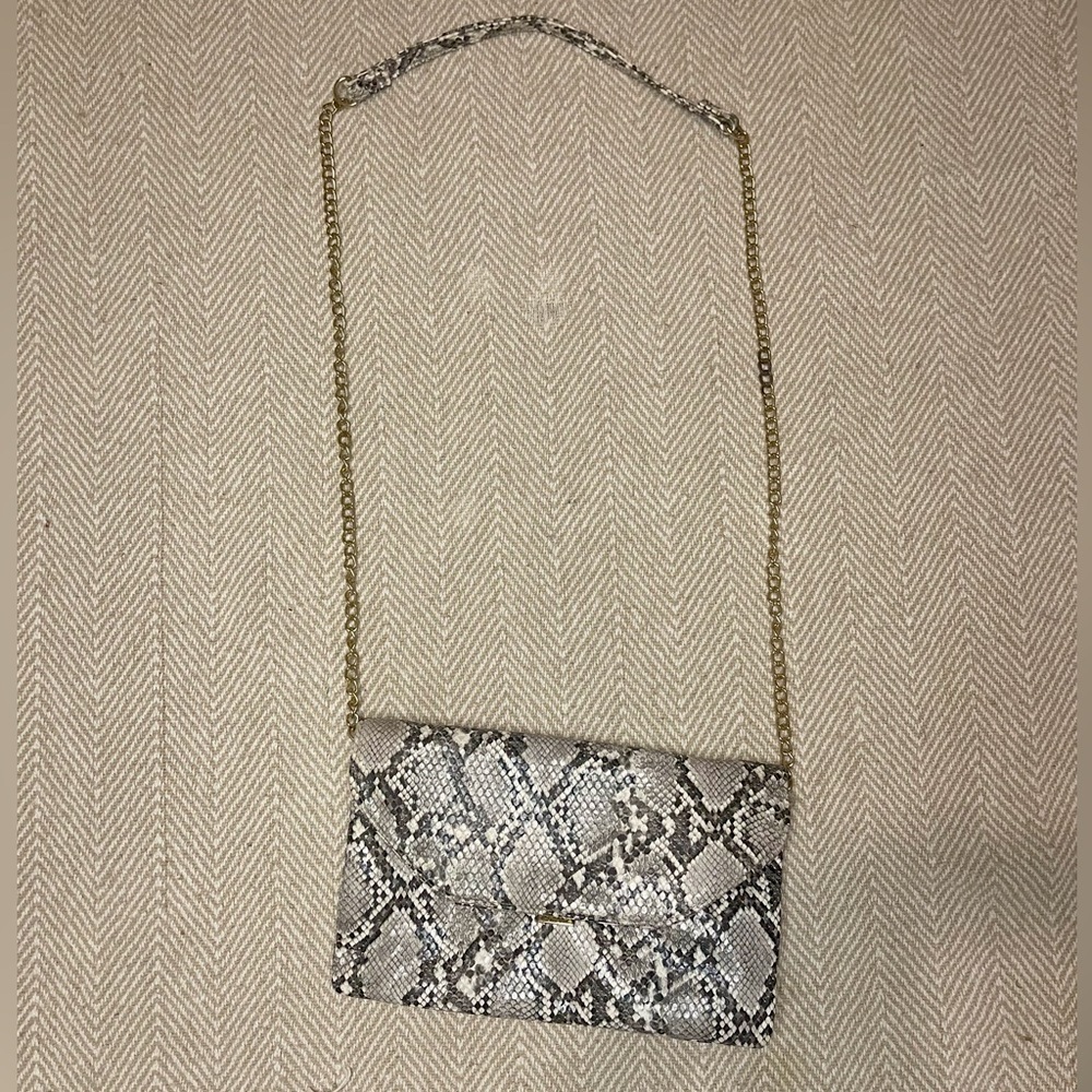 snakeskin bag with three different compartments.